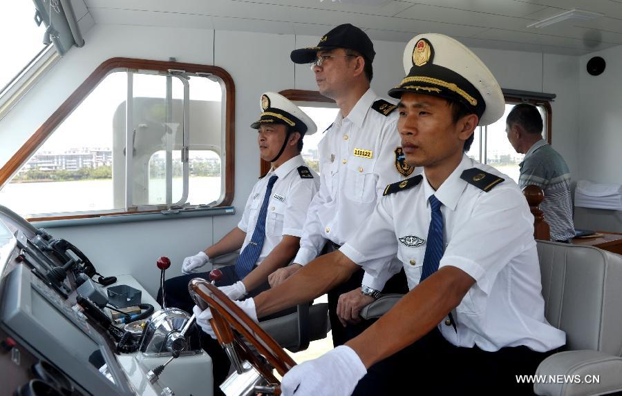 Staff members are on duty monitoring water areas around Boao, south China's Hainan Province, April 3, 2013. A fleet of five marine surveillance ships will monitor maritime traffic safety, investigate maritime accidents, detect pollution, and carry out other missions around the clock during the Boao Forum for Asia Annual Conference 2013 in Hainan. (Xinhua/Zhao Yingquan) 