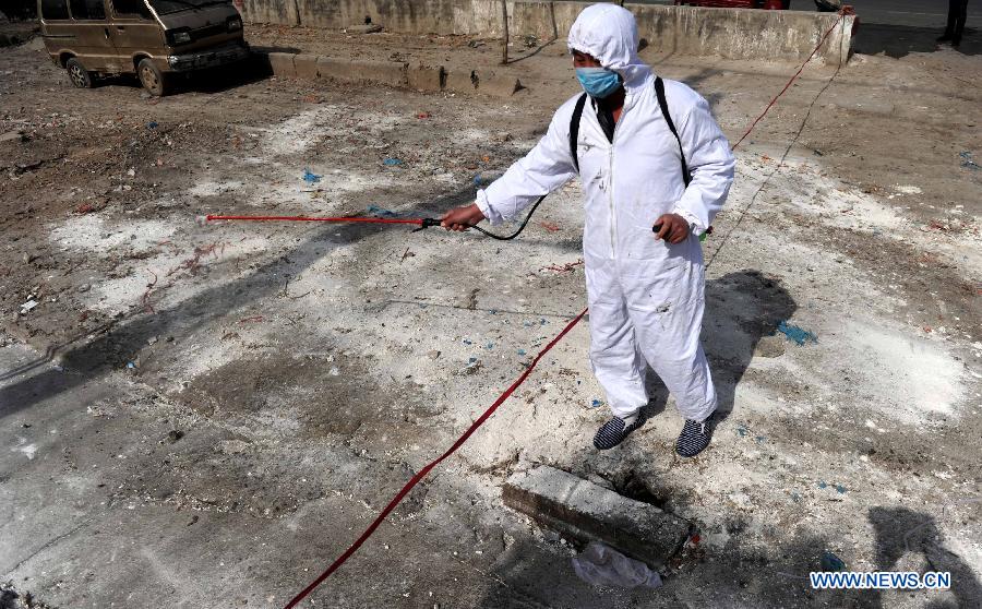 A health worker sprays disinfectant at a closed live poultry stall at a market of farm products in Shuanggou Township of Bozhou City, east China's Anhui Province, April 9, 2013. (Xinhua/Liu Junxi) 