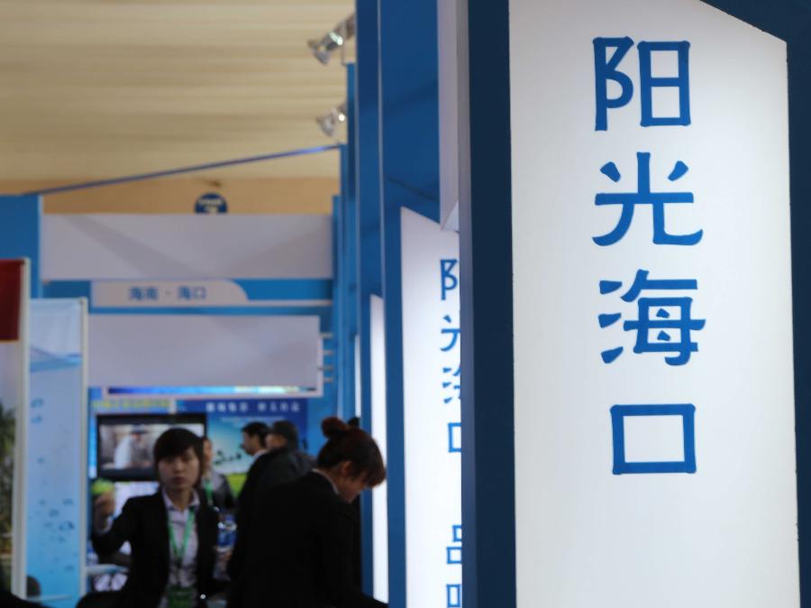 Staff members of a property developer outside Beijing work at 2013 Spring Beijing International Property Expo in Beijing, capital of China, April 11, 2013. The four-day expo kicked off on Thursday at Beijing Exhibition Centre. (Xinhua/Wang Yueling)