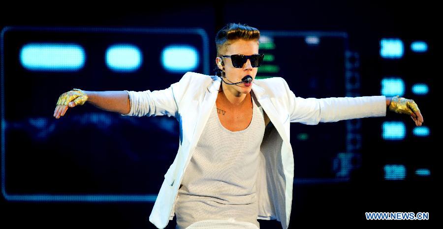 Pop singer Justin Bieber sings during his vocal concert in the gelredome in Arnhem, the Netherlands, April 13, 2013.(Xinhua/Robin Utrecht) 