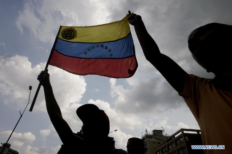 Supporters of opposition leader Henrique Capriles participate in a protest in Caracas, capital of Venezuela, on April 16, 2013. Venezuela's elected President Nicolas Maduro said that he would not allow the opposition to go ahead with a planned protest march on Wednesday through the streets of Caracas. (Xinhua/Juan Carlos Hernandez) 