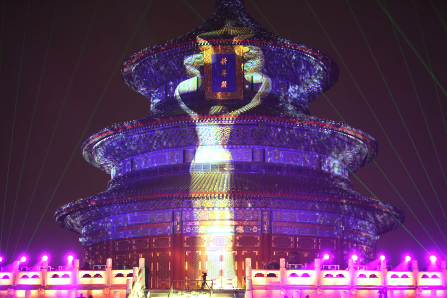 The opening ceremony of the 3rd Beijing International Film Festival is held at 8pm, Tuesday April 16, 2013, at the Hall of Prayer of Good Harvest in the Temple of Heaven Park, Beijing. Gold lighting casts the shape of the "Tiantan Award" as shadows on the Hall of Prayer of Good Harvest. [CRIENGLISH.com, Photo: Zhang Linruo]