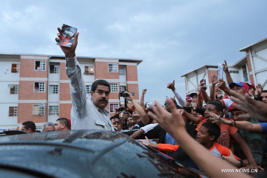 Image provided by the Hugo Chavez Campaign Command shows Venezuelan President-elect Nicolas Maduro (C) taking part in the funeral of a person who died during the clashes after the presidential election, in the municipality of Baruta April 17, 2013. (Xinhua/Hugo Chavez Campaign Command) 