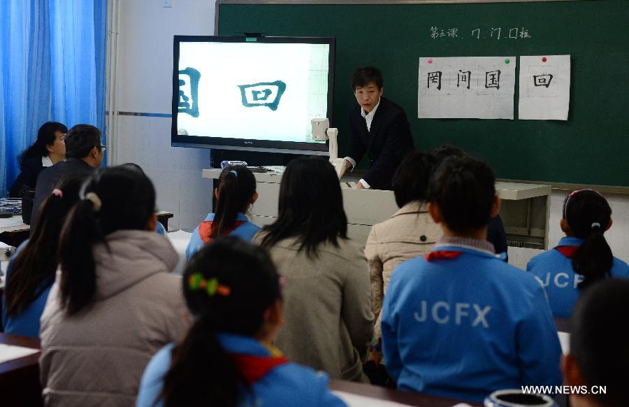 Students attend a calligraphy class at Beijing No. 94 Middle School Airport Campus in Beijing, capital of China, April 18, 2013. The Chinese Ministry of Education has published a guideline on calligraphy education for the country's primary and middle schools in February, setting specific calligraphy course requirements for each period of study and calls for including the courses in evaluations of the schools' performance. In China, calligraphy has been revered as an art form since it was first used in the fifth century BC. (Xinhua/Jin Liangkuai) 