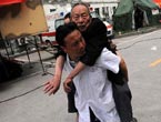 A surgeon carries an injured man on his back to hospital