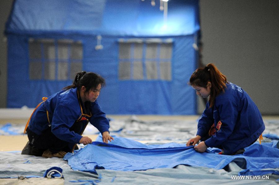 Workers make tents for disaster relief at a company in Deqing County in east China's Zhejiang Province, April 22, 2013. The first 500 tents made by the company are to be sent to southwest China's Sichuan Province, where a 7.0-magnitude earthquake jolted Lushan County of Ya'an City in the morning on April 20. (Xinhua/Ju Huanzong)  