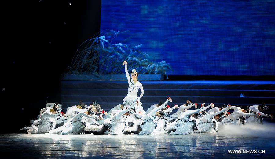 Artists of the Jilin Provincial Performing Troupe perform during a stage show at the Oriental Theatre in Changchun, capital of northeast China's Jilin Province, April 22, 2013. The show, with various art forms including singing, dancing, acrobatics and conjuring, displays folk customs in the Changbai Mountain area. (Xinhua/Xu Chang) 