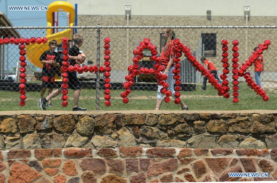 A word "thank" made up of paper cups is seen in a school in West, Texas, the United States, April 22, 2013. (Xinhua/Wang Lei) 