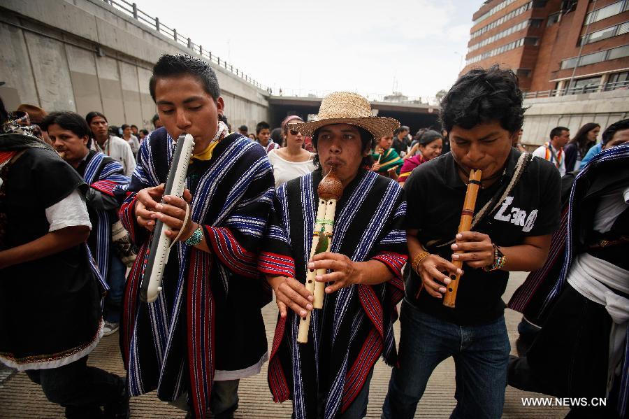 Residents march during the closing ceremony of the "Congress for Peace" in Bogota, capital of Colombia, on April 22, 2013. The "Congress for Peace", organized by the Congress of the People, and attended by some 20,000 people and delegates from 16 countries and regions, ended Monday with a proposed social agenda aimed at finding a solution to the armed conflict in the country, according to local media. (Xinhua/Jhon Paz)