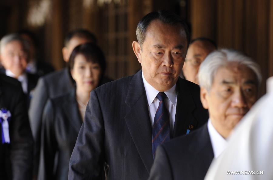 Japanese lawmakers head to visit the Yasukuni Shrine in Tokyo, Japan, on April 23, 2013. Despite repeated strong opposition from China, a group of 168 Japanese lawmakers on Tuesday visited the controversial war-link Yasukuni Shrine in Tokyo, which honors Japanese war criminals of World War II. It marked the first time that the Japanese lawmakers' number exceeded 100 since October 2005, according to local media. (Xinhua) 