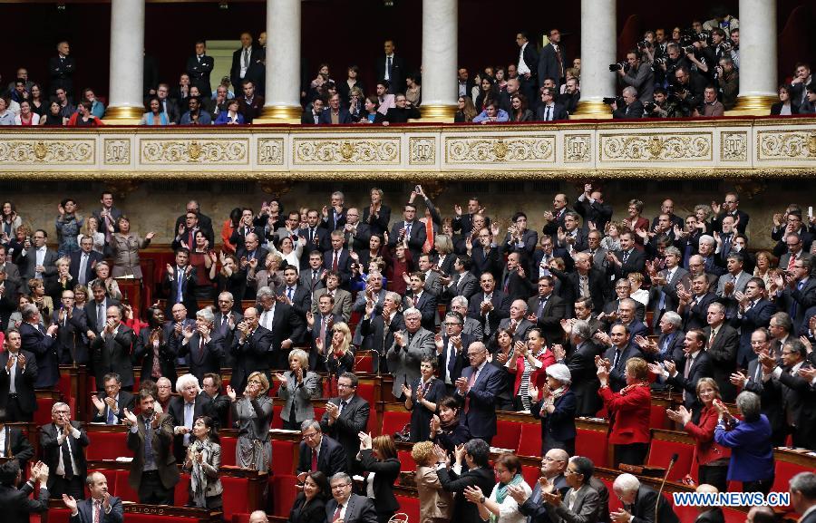 Left wing legislators stand up to welcome the passing of the vote on same-sex marriage at the French Parliament in Paris, France, April 23, 2013. As the ruling Socialist Party (PS) enjoys an absolute majority at the National Assembly where 331 legislators voted for the bill and 225 voted against, it successfully paved the way for France to join dozens of other countries, mostly in Europe, to allow same-sex unions and adoption.(Xinhua/Etienne Laurent)