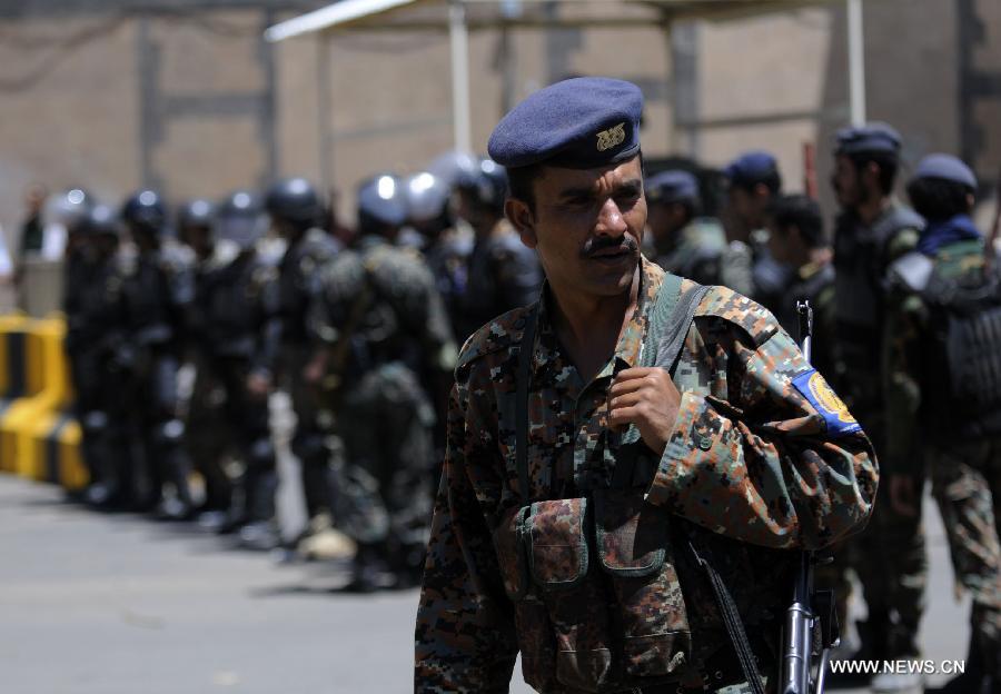 A Yemeni soldier looks at protesters who hold a rally outside the U.S. embassy in Sanaa against drone strikes in Yemen, on April 29, 2013. Yemeni activists staged a rally on Monday to denounce U.S. drone strikes in Yemen. The U.S. has stepped up drone attacks against al-Qaeda militants in Yemen's southern regions this year which killed dozens of civilians and sparked mass protests. (Xinhua/Mohammed Mohammed)  