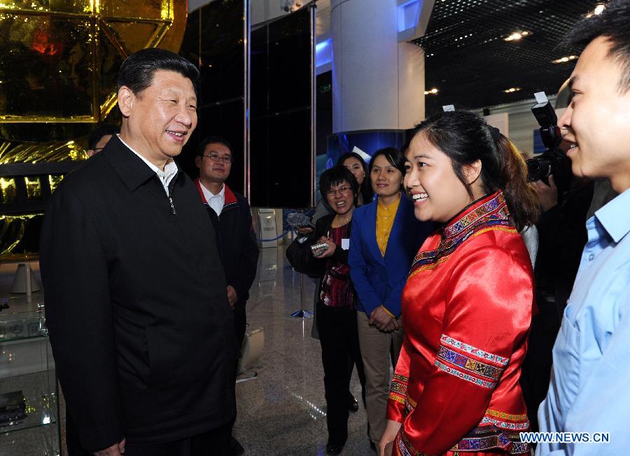 Chinese President Xi Jinping (L) talks with representatives of model youth before joining a discussion to mark the country's Youth Day on Saturday at China Academy of Space Technology in Beijing, capital of China, May 4, 2013. Xi on Saturday called on Chinese young people to contribute to the revitalization of the nation and "hone themselves at grassroots." (Xinhua/Rao Aimin)