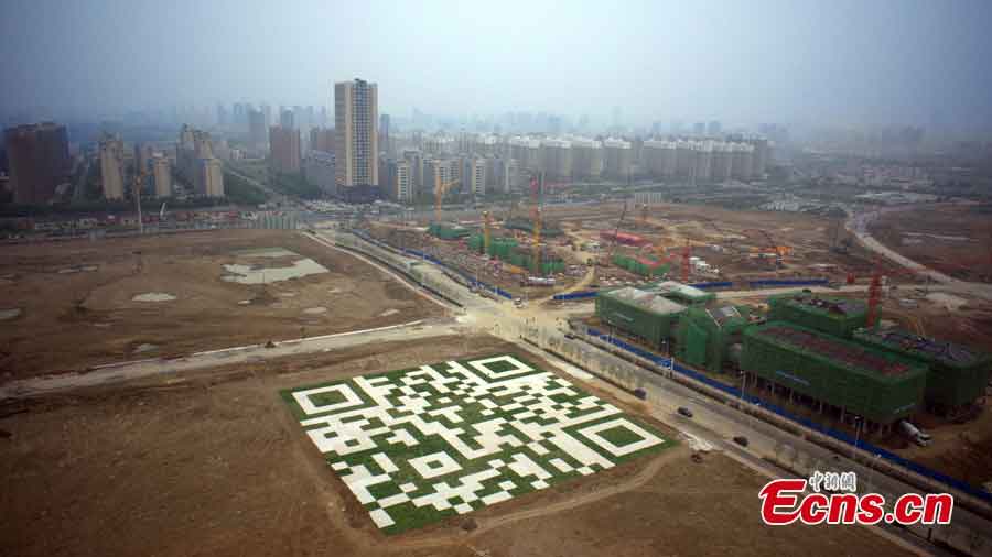 A huge lawn with a 2-dimensional bar code is seen at a construction site in Hefei, Anhui Province, May 16, 2013. The lawn, about 6,400 square meters, can be decoded by smartphone apps from above to play music and videos. (CNS/Zhang Yazi)