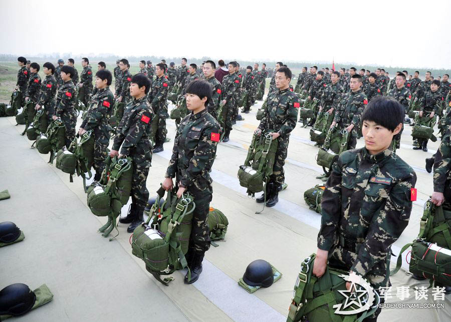 The members from the first female special operation company of the Army of the Chinese People's Liberation Army (PLAA) are in their first parachute landing training on May 14, 2013. (China Military Online/Cheng Jianfeng, Yan Xingxing)