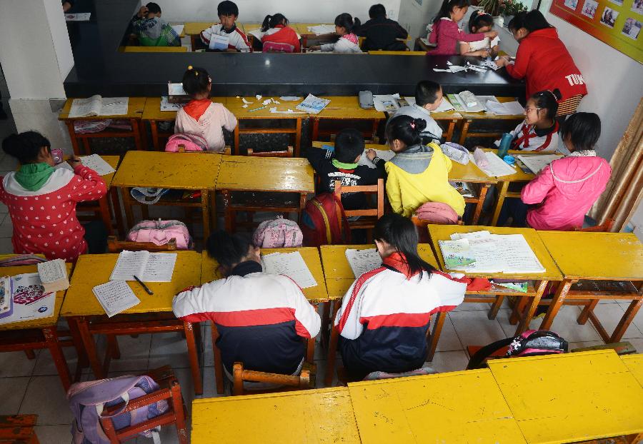 Left-behind children, whose parents go to other places to work, do their homework at an after-school care center in Danying Community of Yanji City, Yanbian Korean Autonomous Prefecture in northeast China's Jilin Province, May 22, 2013. More than 30,000 children are left behind by their parents who choose to go to South Korea to work in the Yanbian Korean Autonomous Prefecture. The local government established 20 after-school care centers to provide these left-behind children with the after-class care. (Xinhua/Lin Hong)