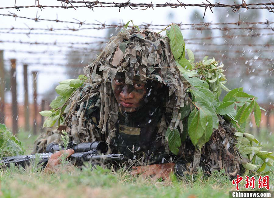 Snipers of the Chinese People's Liberation Army (PLA) participate in military training at a base in Chengdu, Southwest China's Sichuan Province, May 22, 2013. Altogether snipers from over 40 troops of more than 10 corps including the army, navy, air force and the Second Artillery Corps took part in the 40-day training that concluded on Wednesday. [Photo: CNS/Wu Sulin] 