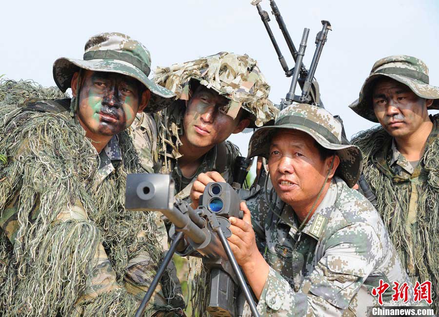 Snipers of the Chinese People's Liberation Army (PLA) participate in military training at a base in Chengdu, Southwest China's Sichuan Province, May 22, 2013. Altogether snipers from over 40 troops of more than 10 corps including the army, navy, air force and the Second Artillery Corps took part in the 40-day training that concluded on Wednesday. [Photo: CNS/Wu Sulin] 