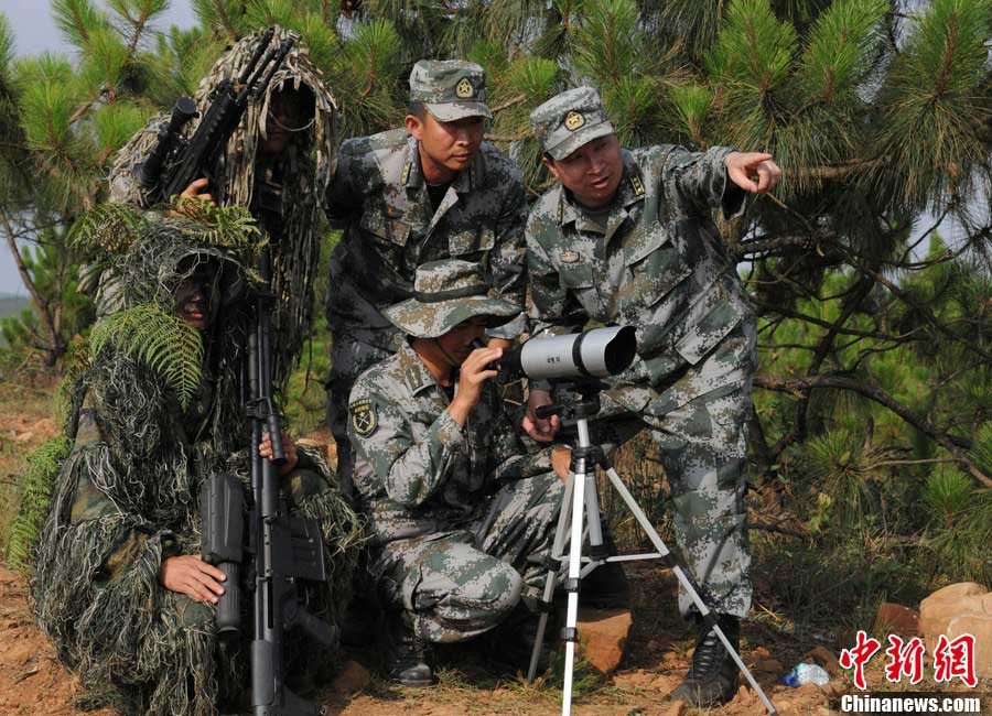 Snipers of the Chinese People's Liberation Army (PLA) participate in military training at a base in Chengdu, Southwest China's Sichuan Province, May 22, 2013. Altogether snipers from over 40 troops of more than 10 corps including the army, navy, air force and the Second Artillery Corps took part in the 40-day training that concluded on Wednesday. [Photo: CNS/Wu Sulin] 