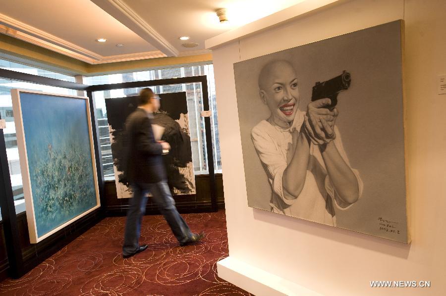 A man visits the 2013 Asia Contemporary Art Show in Hong Kong, May 23, 2013. The art show, which exhibits about 2, 000 artworks from 16 countries and regions, opened here on Thursday. (Xinhua/Lv Xiaowei) 