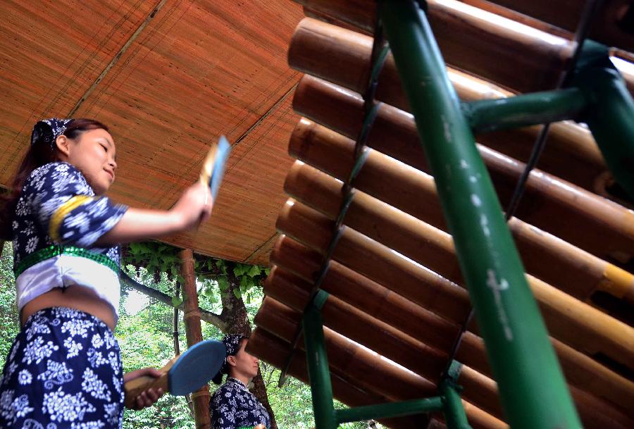 Bandswomen play musical instruments made with bamboo at the Lanxi Valley Rain Forest Scenic Area in Chongyi County, east China's Jiangxi Province, May 28, 2013. Chongyi boasts of abundant resources of moso bamboo. (Xinhua/Wang Song) 