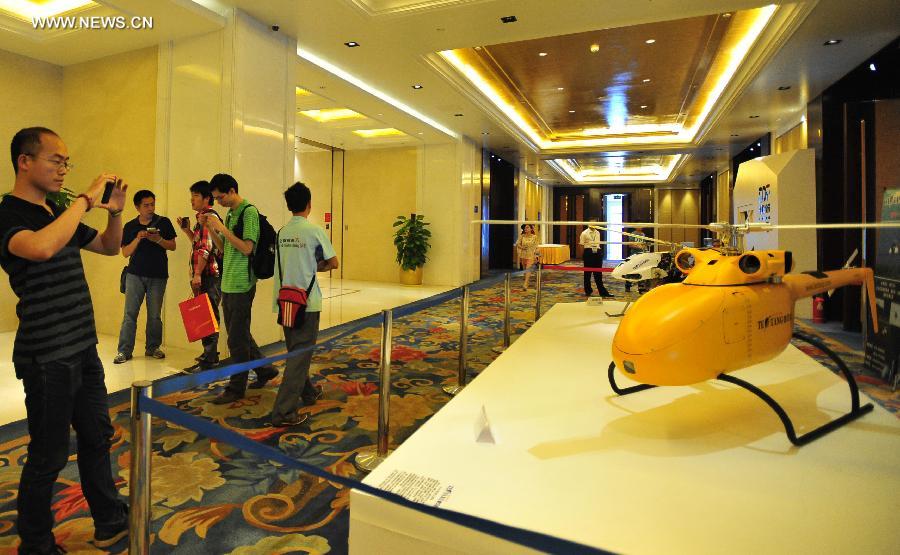 A visitor takes a photo of a drone at the International Design Expo in Beijing, capital of China, May 30, 2013. Opened Thursday, the expo is part of the 2013 China Design Festival from May 30 to June 1 in Beijing's Daxing District. (Xinhua/He Canling) 