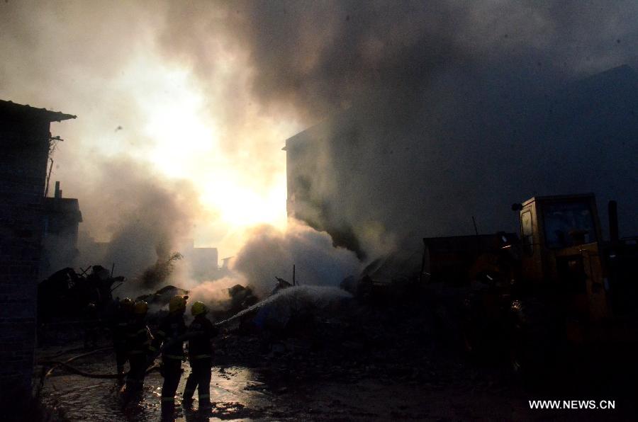 Firemen spray water at the scene of a fire at Daxin Village in Yulin City, south China's Guangxi Zhuang Autonomous Region, early June 2, 2013. The fire broke out at a storehouse early Sunday and was put out after hours by local fire department. The fire burned an area of some 3,000 square meters, with no casualties reported. (Xinhua/Wei Gongbing)