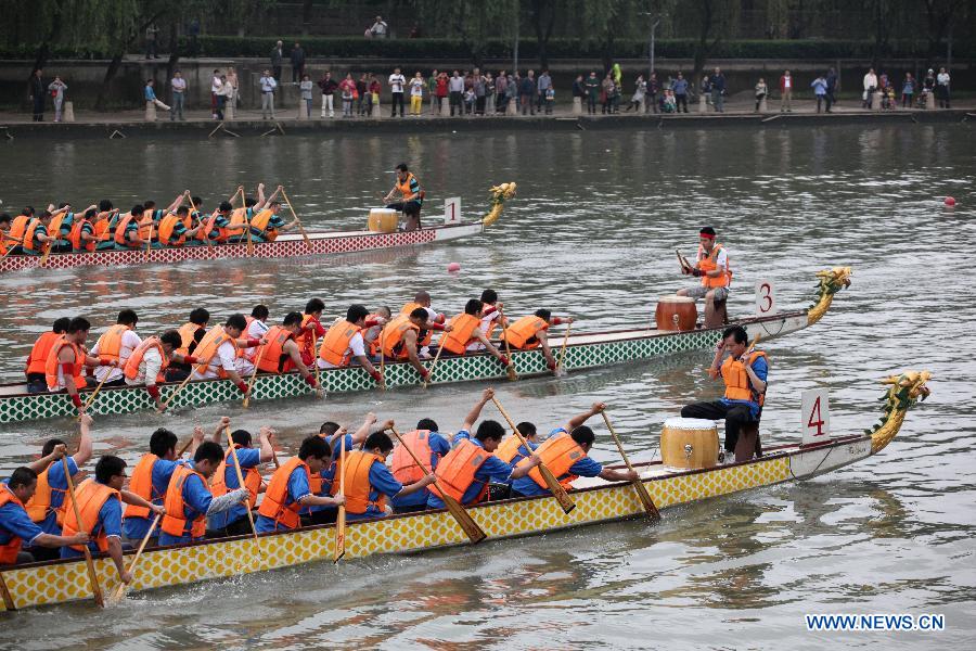 Participants compete in a dragon boat race during a dragon boat carnival on the Qinhuai River in Nanjing, capital of east China's Jiangsu Province, June 2, 2013. The event was held as a means to celebrate the upcoming Dragon Boat Festival, or Duanwu Festival, which falls on the fifth day of the fifth month in the Chinese lunar calendar, or June 12 this year. (Xinhua/Li Wenbao)