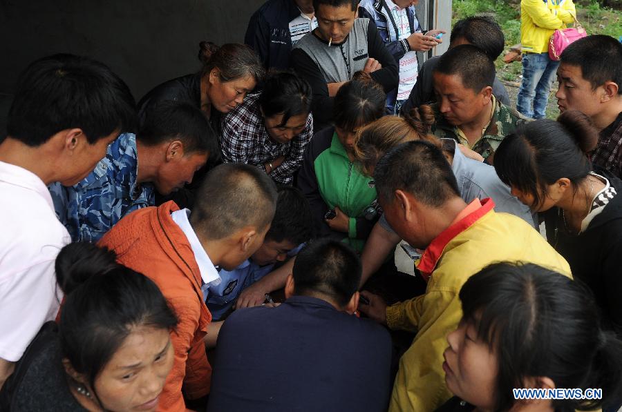 Family members of missing workers register information after a fire occurred in a slaughterhouse owned by the Jilin Baoyuanfeng Poultry Company in Mishazi Township of Dehui City, northeast China's Jilin Province, June 3, 2013. Death toll from the poultry processing plant fire on Monday morning has risen to 119. Over 300 workers were in the plant when the accident happened. (Xinhua/Xu Chang)