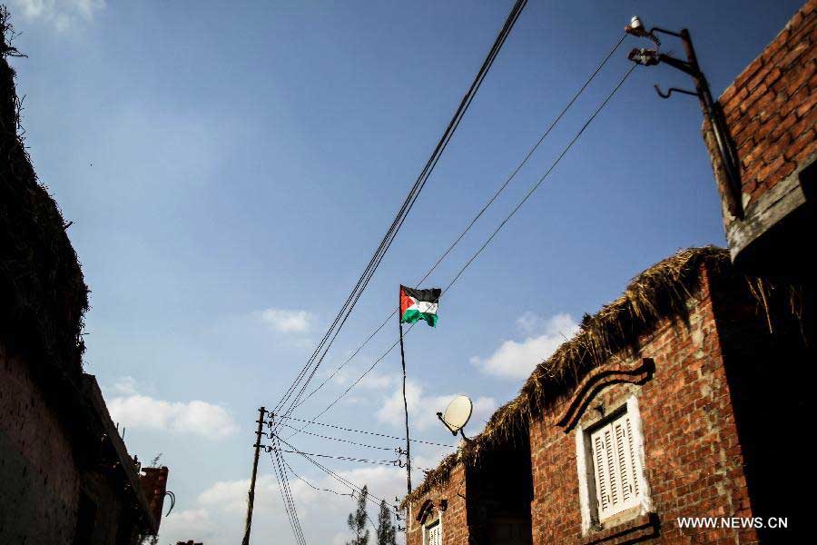 A Palestinian flag is seen in Fadel Island refugee camp in Sharqia, 90km northeast of Cairo, Egypt, June 10, 2013. Fadel Island village is a forgotten Palestinian refugee camp in Egypt, with about 4,000 Palestinian refugees who came to Eygpt since 1948 living in it. Refugees there are living in very harsh circumstances as the camp lacks of infrastructure, health care, education and jobs. As United Nations Relief and Works Agency for Palestine Refugees in the Near East (UNRWA) does not porvide direct service in Egypt, Egyptian government is alone responsible for these refugees. (Xinhua/Amru Salahuddien)