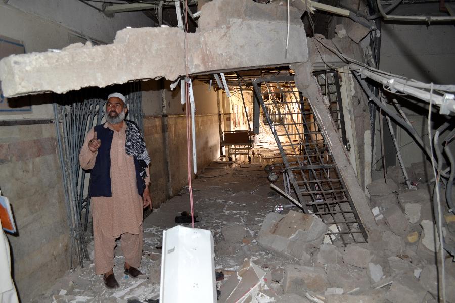 A Pakistani man looks at the damage of a hospital a day after militants attacked it in southwest Pakistan's Quetta, June 16, 2013. A day of mourning was observed across Pakistan's southwestern Balochistan province on Sunday over Saturday's bombings targeting the Women University bus and the Bolan Medical Complex which has claimed 20 precious lives. (Xinhua/Asad)