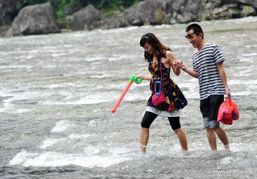 People play on a water square in Pingnan County, Ningde City, southeast China's Fujian Province, June 21, 2013. (Xinhua/Hu Guolin)  