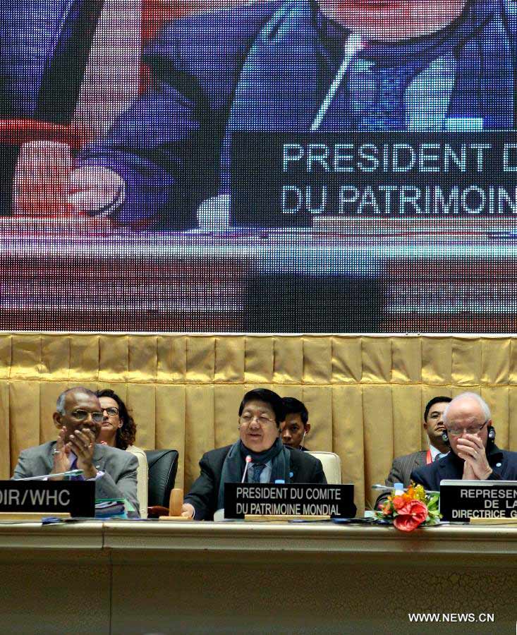 Cambodian Deputy Prime Minister and chairman of the 37th session of the World Heritage Committee Sok An (C front) declares that Hani Terraces became a World Heritage Site in Phnom Penh, Cambodia, June 22, 2013. The UNESCO's World Heritage Committee inscribed China's cultural landscape of Honghe Hani Rice Terraces onto the prestigious World Heritage List on Saturday, bringing the total number of World Heritage Sites in China to 45. (Xinhua/Li Ying)  