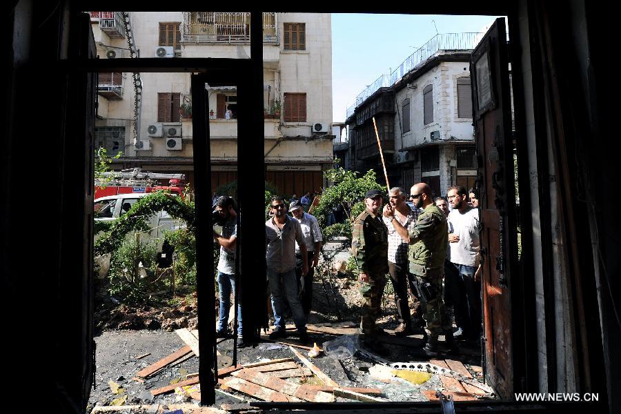 Security members inspect the site of blast in Damascus, capital of Syria, on June 27, 2013. At least four people were killed and many others wounded when a suicide bombing struck near the Mariamieh Patriarchate in the old quarter of the Syrian capital Damascus on Thursday, local media said. (Xinhua/Zhang Naijie) 