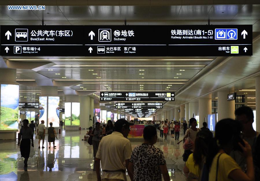 Passengers are seen at the newly-opened Hangzhou East Station in Hangzhou, capital of east China's Zhejiang Province, July 1, 2013. With the building area of 1.13 million square meters, the Hangzhou East Station, China's largest railway terminal, officially opened on Monday. (Xinhua/Sun Can)