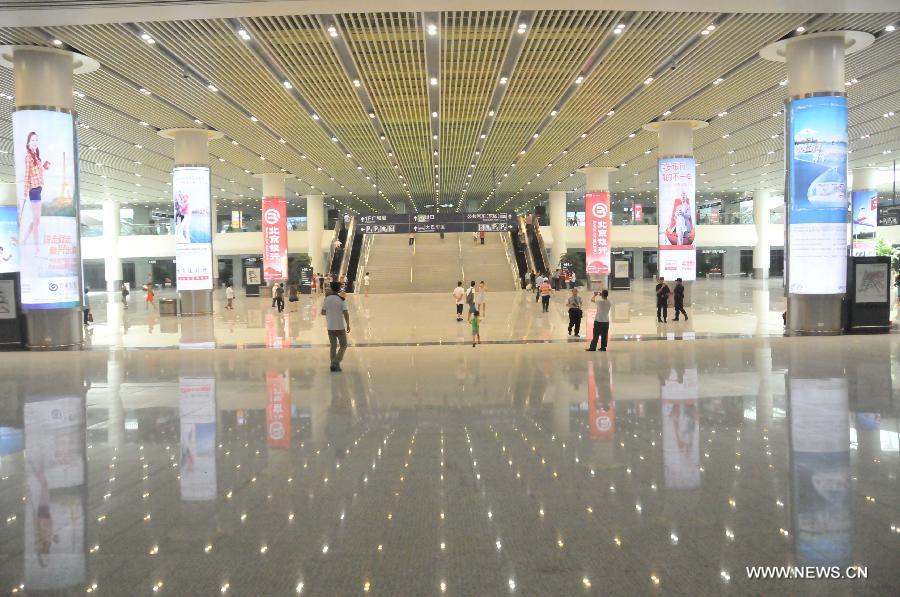 People walk inside the newly-opened Hangzhou East Station in Hangzhou, capital of east China's Zhejiang Province, July 1, 2013. With the building area of 1.13 million square meters, the Hangzhou East Station, China's largest railway terminal, officially opened on Monday. (Xinhua/Zhu Yinwei) 