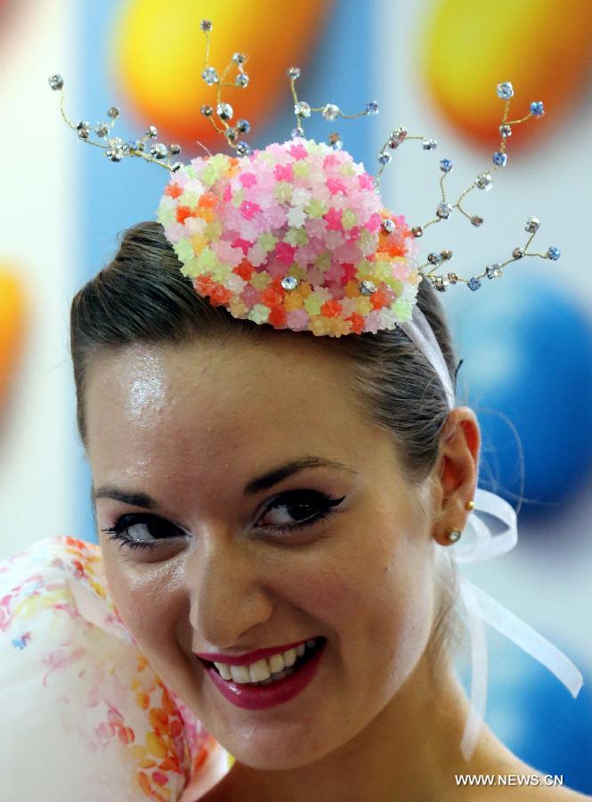 A model presents a headwear made of candies designed by Hong Kong designer Lilian Kan at Citygate Outlets in south China's Hong Kong, July 8, 2013. Kan showed her self-designed shoes and apparels made of candies here on Monday. (Xinhua/Li Peng) 