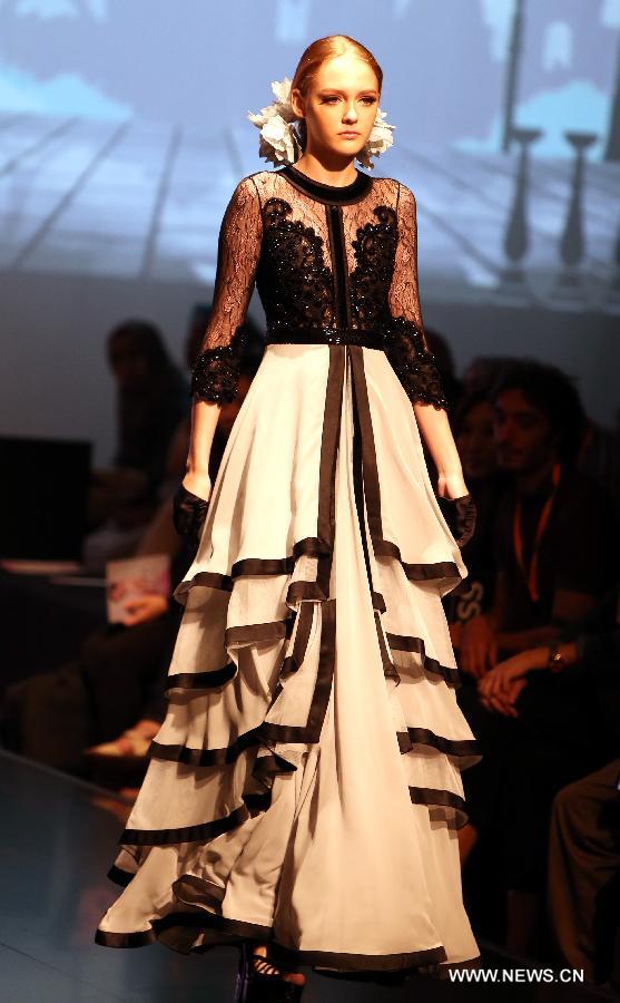 A model presents a creation of a brand at the 20th Hong Kong Fashion Week for Spring/Summer in south China's Hong Kong, July 10, 2013. The four-day fair, which is organized by the Hong Kong Trade Development Council, kicked off at the Hong Kong Convention and Exhibition Center Monday. (Xinhua/Li Peng)