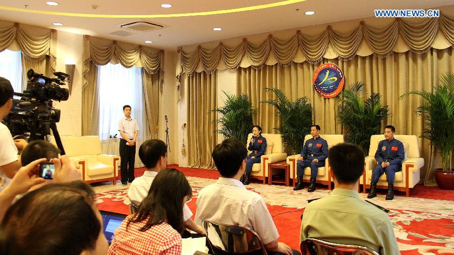 Astronauts of China's Shenzhou-10 mission Nie Haisheng (2nd R back), Zhang Xiaoguang (1st R back) and Wang Yaping (3rd R back) are present at a press conference in Beijing, China, July 11, 2013. The three astronauts have completed their medical quarantine and are in good conditions, according to official sources. (Xinhua/Liu Fang) 