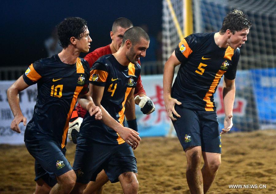 Australian players celebrate after winning the men's beach soccer match against Vietnam at the 4th Asian Beach Games in Haiyang, east China's Shandong Province, July 11, 2013. Australia won 7-2. (Xinhua/Zhu Zheng)