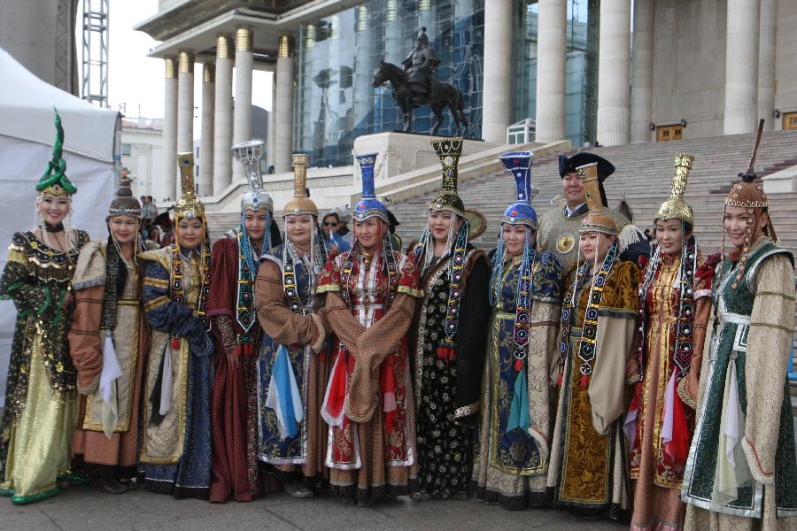 Models present traditional Mongolian clothes during the annual Mongolian Clothing Festival in Ulan Bator, Mongolia, July 20, 2013. (Xinhua/Shi Yongchun)