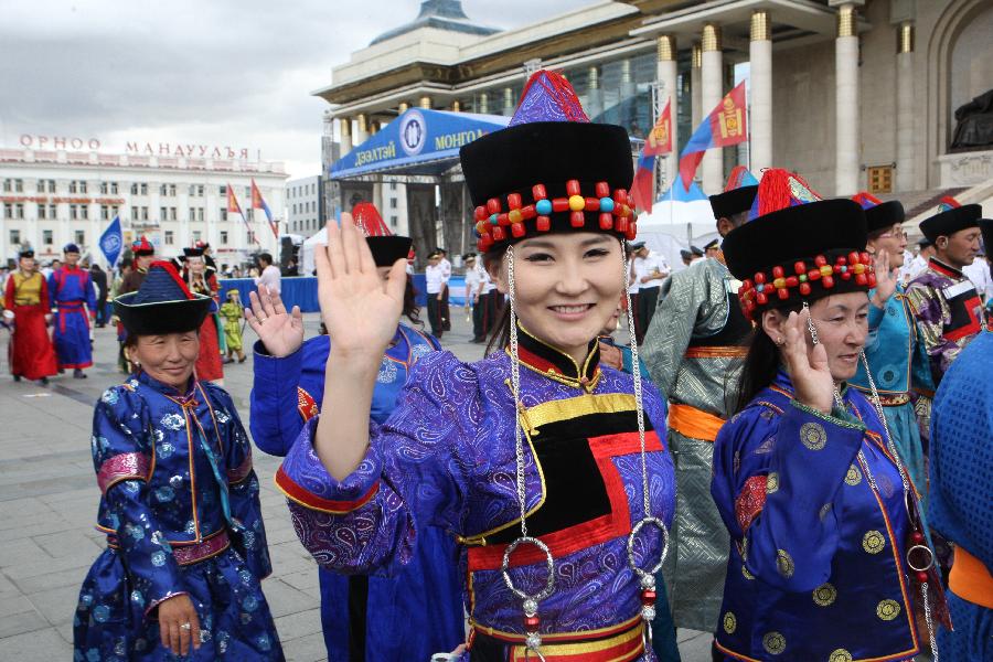 Models present traditional Mongolian clothes during the annual Mongolian Clothing Festival in Ulan Bator, Mongolia, July 20, 2013. (Xinhua/Shi Yongchun)