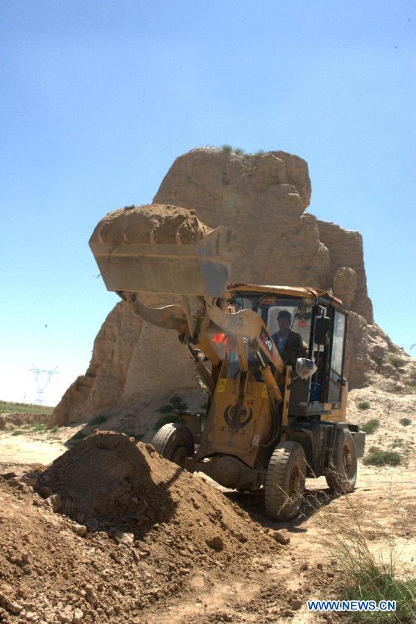 A worker works at the construction site for protecting the Great Wall in Shandan County, northwest China's Gansu Province, July 19, 2013. This year, the local authorities has allocated more than 30 million yuan (about 4.89 million U.S. dollars) for the protection of the Great Wall in Shandan County, which was built in the Ming Dynasty (1368-1644) and has a length of 88 kilometers. (Xinhua/Yin Xubao)