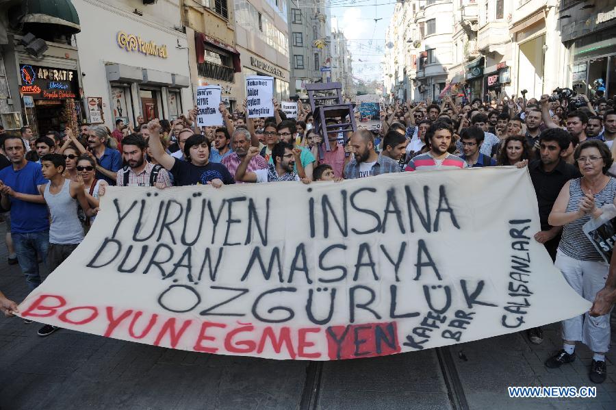 People participate in a demonstration in Istanbul on July 21, 2013. Around two thousand people carrying tables and chairs gathered on the Istiklal Avenue, staged a demonstration on Sunday to protest against the municipality's ban on outdoor sitting. The protest marks the second anniversary of the ban on July 21. In 2011 municipality officials removed the street-side tables around Beyoglu's main thoroughfare Istiklal and the upscale Cihangir neighborhood which fueled public outrage. (Xinhua/Lu Zhe) 