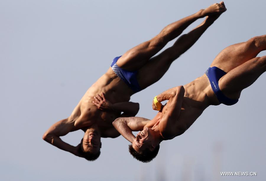 Germany's Sascha Klein (L) and Patrick Hausding compete during the men's 10m synchro platform final of the Diving competition in the 15th FINA World Championships at the Piscina Municipal de Montjuic in Barcelona, Spain, on July 21, 2013. Sascha Klein and Patrick Hausding claimed the title with a total socre of 461.46 points. (Xinhua/Wang Lili)