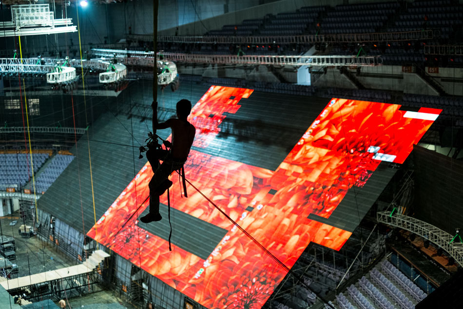 Zhou, 23, works high above the ground to install the wire lines for the acrobatic show at the opening ceremony of Asian Youth Council in Nanjing, east China's Jiangsu province on July 11, 2013. The temperature in Nanjing reached 37 degrees Celsius. Zhou has to work in the high temperature for at least 7 or 8 hours every day. (Xinhua/Li Mangmang)