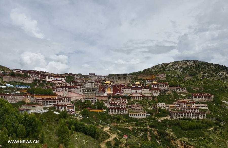 The annual religious ritual of unfolding a huge Buddha portrait is held in the Gandan Temple in Lhasa, capital of southwest China's Tibet Autonomous Region, July 22, 2013. Founded in 1409 by followers of Zong Kaba, founder of the Yellow Sect of Tibetan Buddhism, the Gandan Temple is the oldest among lamaseries of the Yellow Sect. (Xinhua/Purbu Zhaxi)