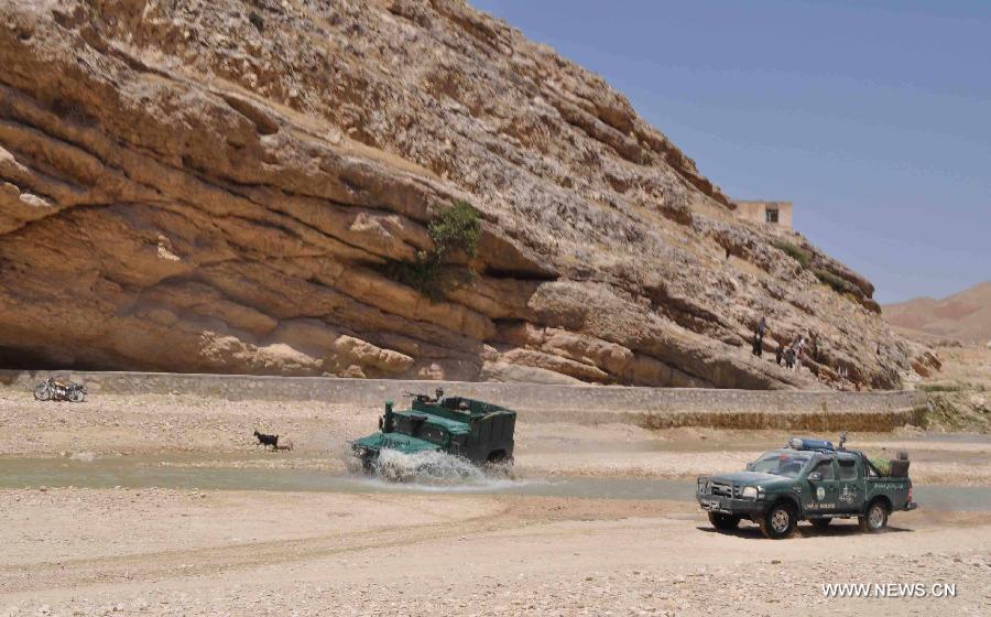 Afghan policemen patrol with their military vehicles during an operation against Taliban in Jawzjan province, northern Afghanistan, on July 24, 2013. (Xinhua/Arui)