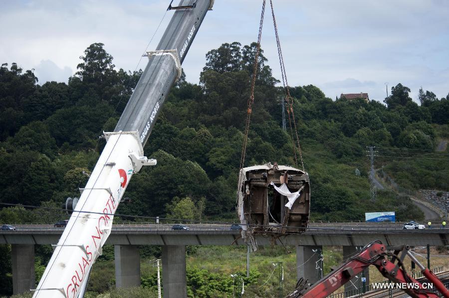 Rescuers work at the accident site at the entrance of Santiago de Compostela Station, in the autonomous community of Galicia, northwest of Spain, on July 25, 2013. The death toll has risen to at least 80 after a train derailed outside the city of Santiago de Compostela on late July 24, according to the police. (Xinhua/Xie Haining)