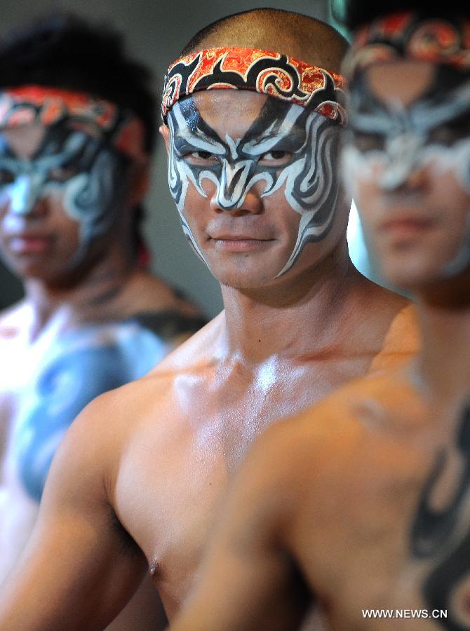 Dancers perform in the press conference of the Dance Drama "Drum God" in Taipei, southeast China's Taiwan, July 26, 2013. The Dance Drama "Drum God" held by two cross-strait ensembles will be performed on Aug. 10 in Taichung City.(Xinhua/Tao Ming)